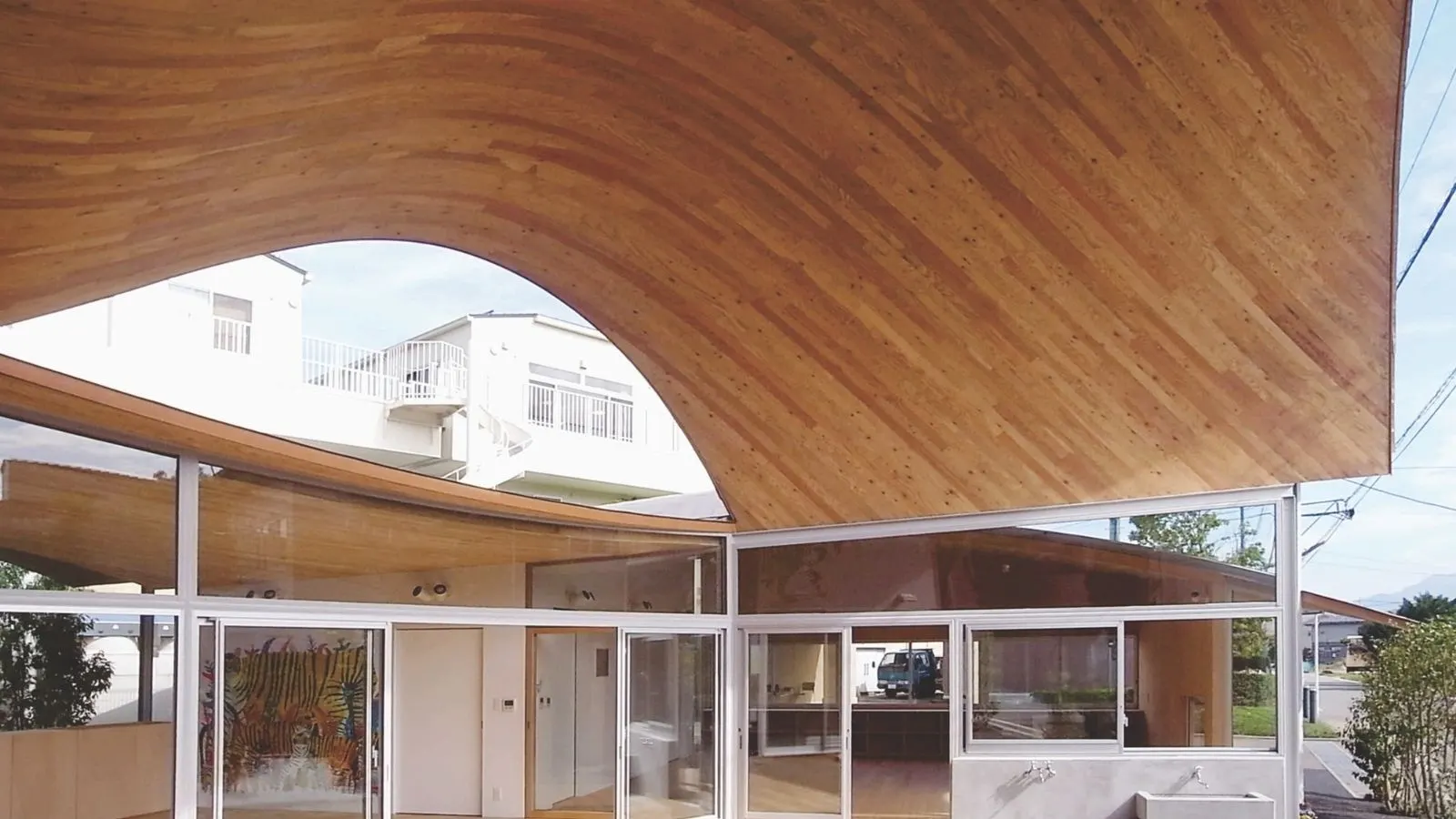 Toranoko Nursery in Japan Creates a Community Space Beneath a Sculptural Curved Roof